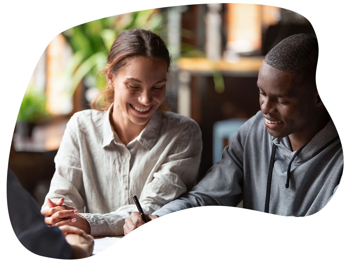 Image of a couple signing a mortgage. 