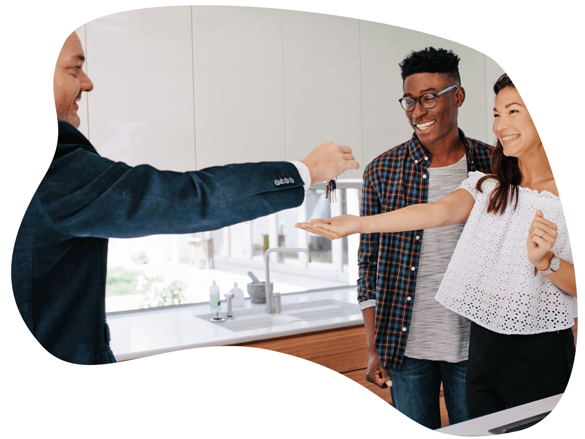 Real estate agent handing over keys of new home to young couple