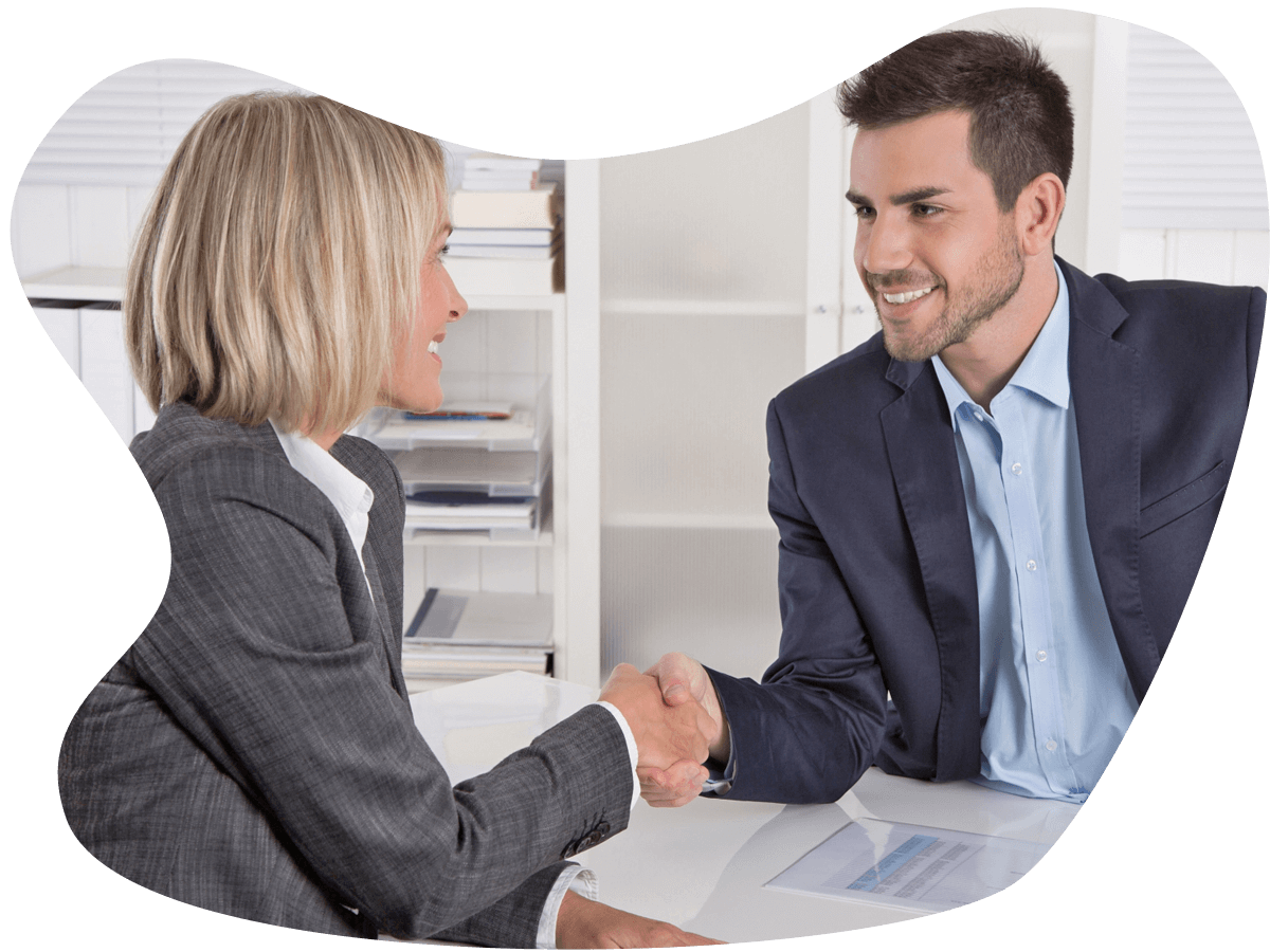 Female realtor shakes hand with a man over a kitchen island