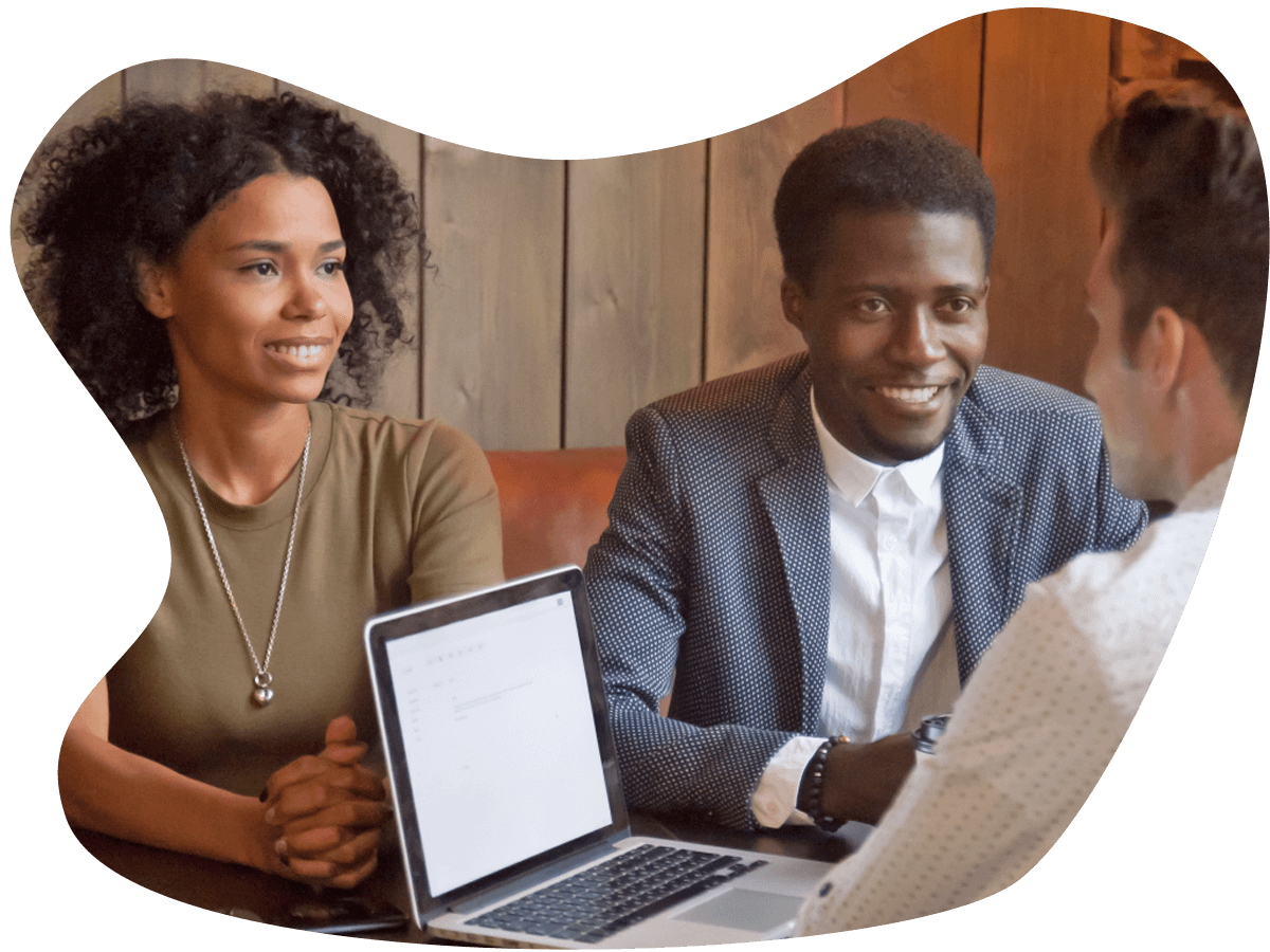 A straight black couple sits across from a mortgage specialist